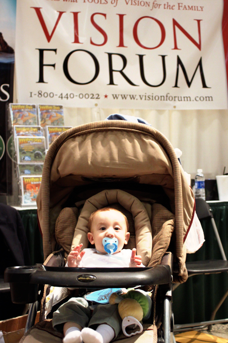 The secret to strong book sales? Strategic position of a cute baby behind the book table.