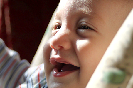 A super-close-up of Calvin near the window in his highchair